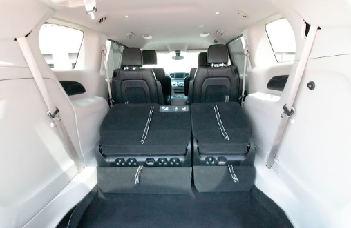  Inside view of a car’s cabin highlighting plush seats and generous legroom for passengers.