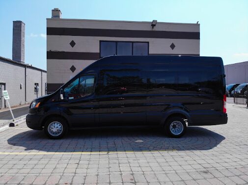 Spacious rental minivan parked near scenic Michigan highway, ready for a family road trip.