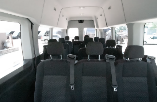 Wide view of comfortable seats and roomy interior of a rental van designed for group trips.