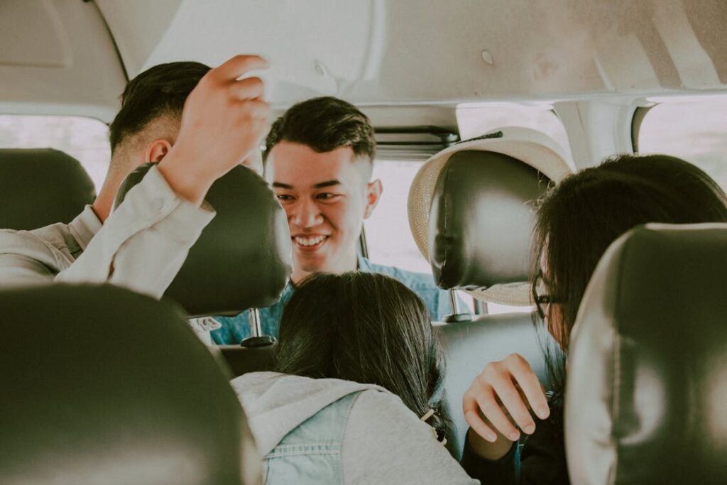 Employees enjoying a fun and cheerful moment together while traveling in a car
