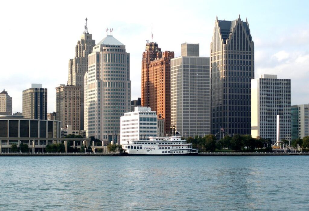 Detroit skyline at sunset with modern buildings and a riverfront view