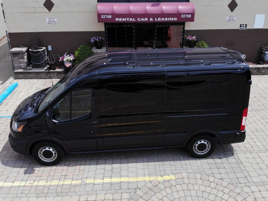 A rental van of the MI fleet parked outside the office