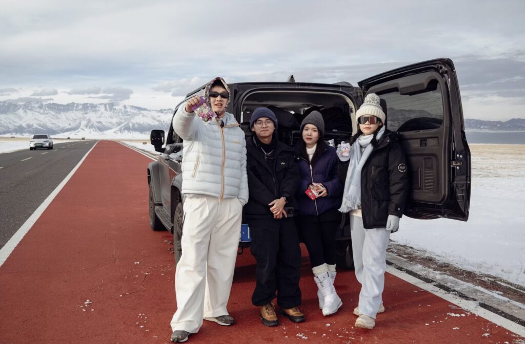 This photo shows a group of friends standing outside a parked van