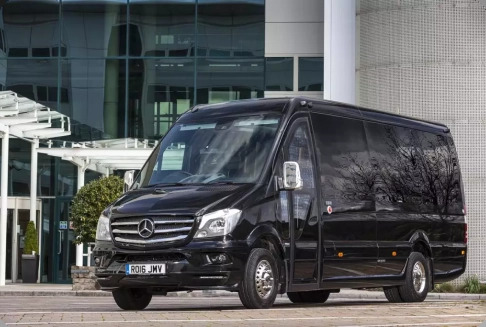 a black passenger van parked in front of a building