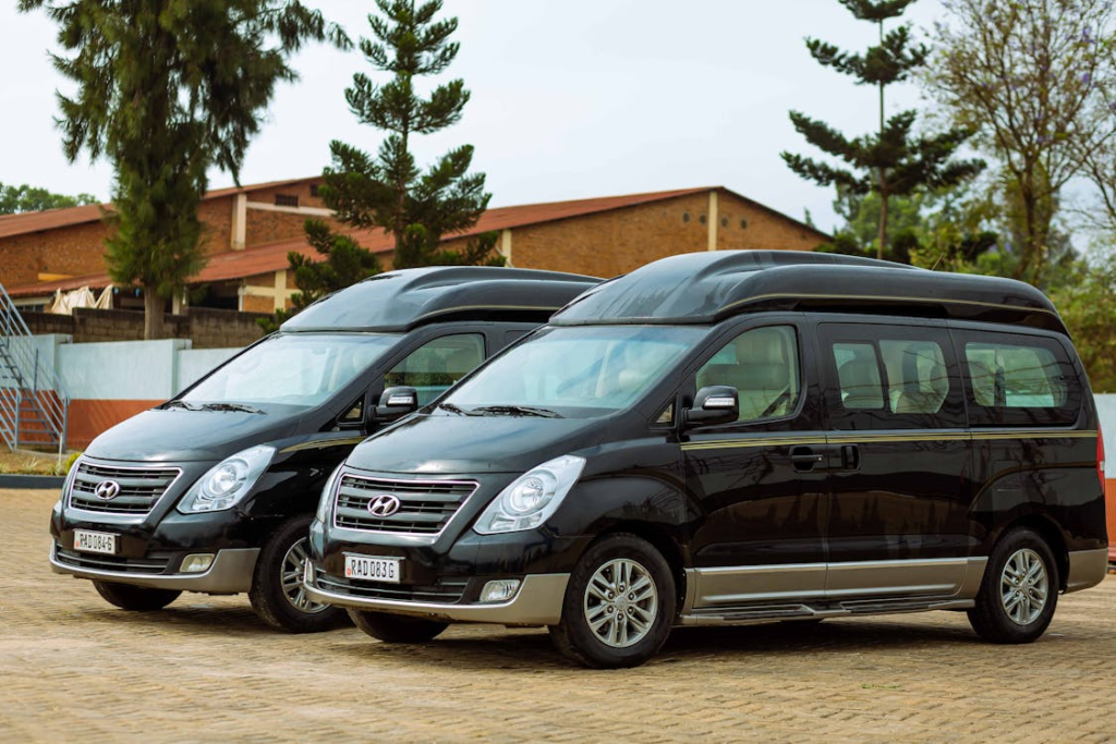 A pair of black 12-passenger vans