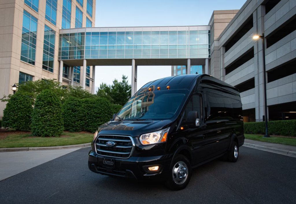 Black passenger van ready for a corporate group traveling to a business event