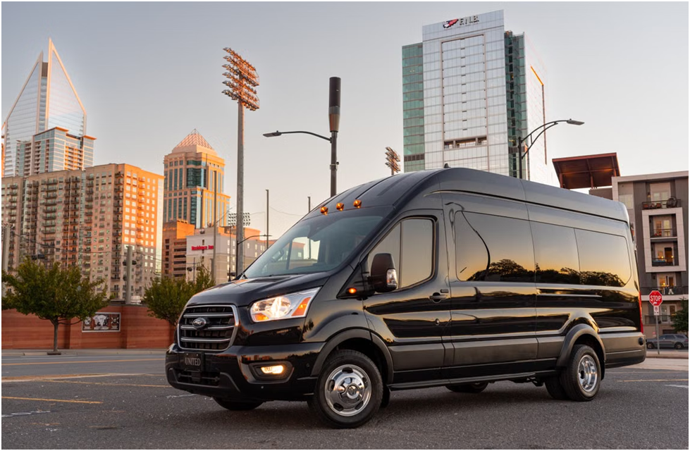A black passenger van parked outdoors