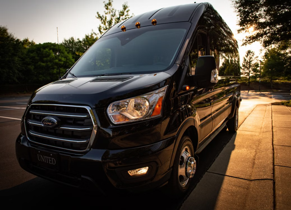 Black passenger van parked near an autumn landscape in Michigan
