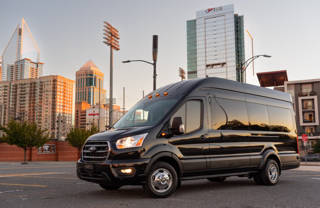 Black passenger van parked outside a Michigan destination during autumn